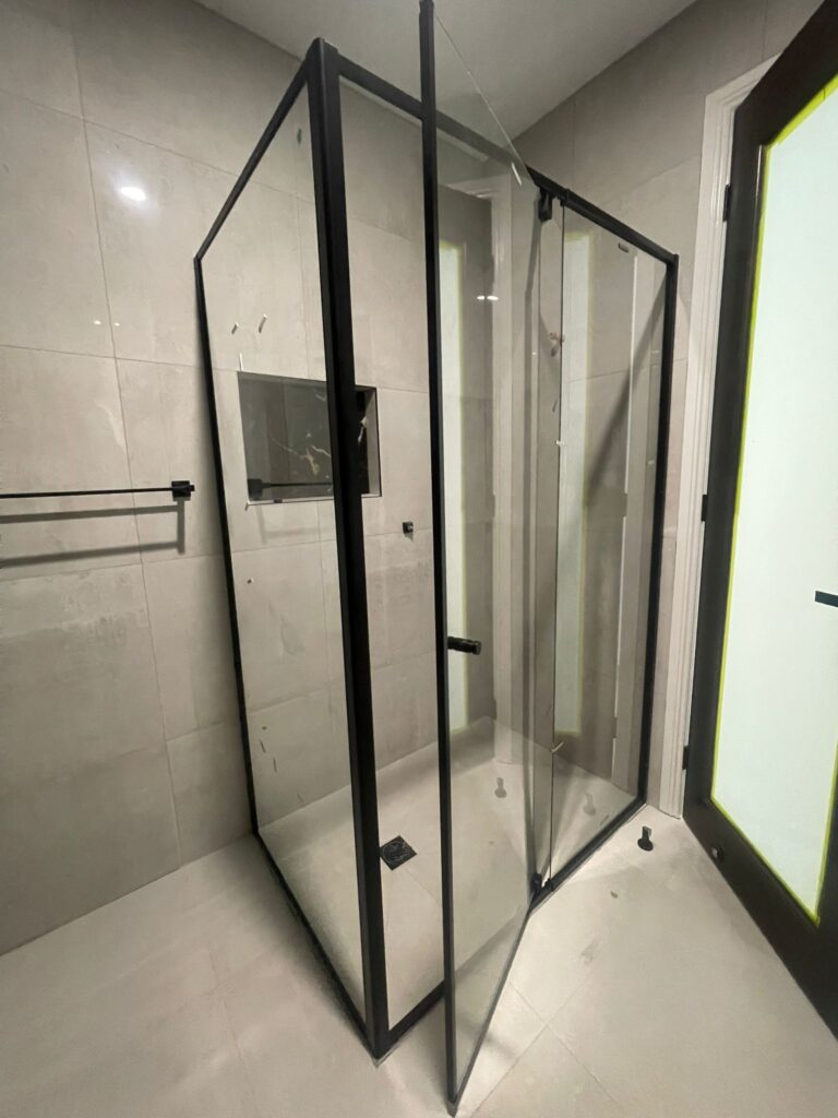 Modern walk-in glass shower with black profile hardware